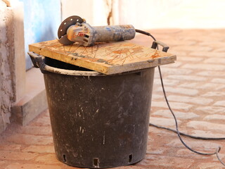 Angle grinder, a hand tool used for cutting, grinding, or polishing various materials such as...