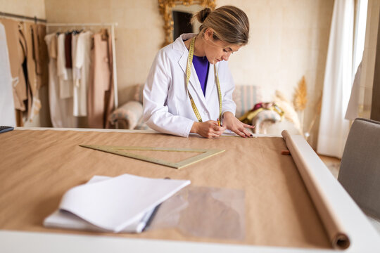 Fashion designer drafting garment patterns