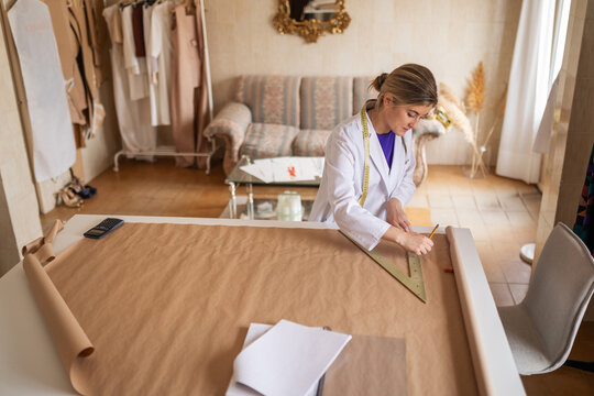 Fashion designer drafting garment patterns