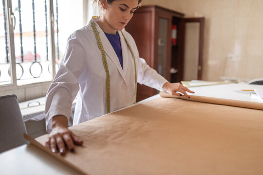 Fashion designer drafting garment patterns