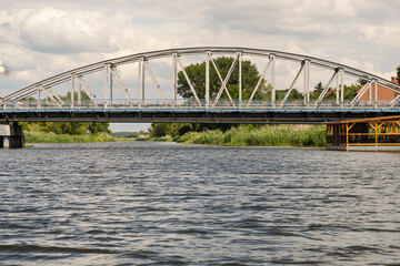 A bridge spans a river, with a view of the water below