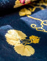 Delicate gold embroidery on dark blue fabric