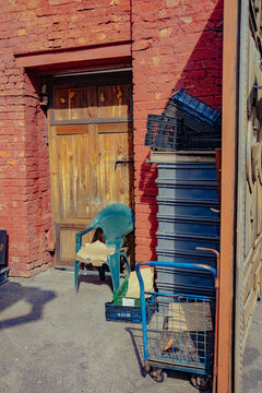 Old door with peeling paint and crates in bright sunlight outside