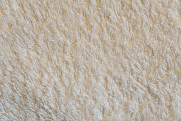 A close up of a white carpet with a fuzzy texture