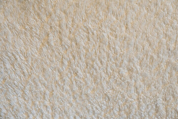 A close up of a white carpet with a fuzzy texture