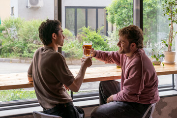 Friends Toasting with Beer at Cafe