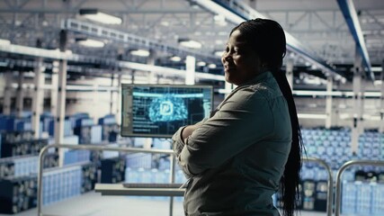 Portrait of smiling IT professional in server farm optimizing machine learning systems handling tasks. Happy data center female engineer adjusting neural networks AI model parameters, camera B