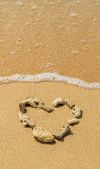 A heart made from coral on beautiful golden sandy beach Barbados