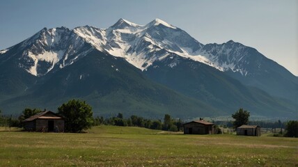 Naklejka premium Serene Mountain Landscape with Rustic Barns