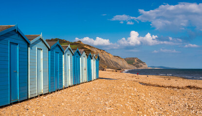 Charmouth Beach huts after a storm washes up flotsam and jetsam