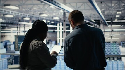 Team of server room technicians alerted by warning message on laptop causing infrastructure slowdowns. Teamworking data center colleagues see malfunction popup caused by software errors, camera B - Powered by Adobe