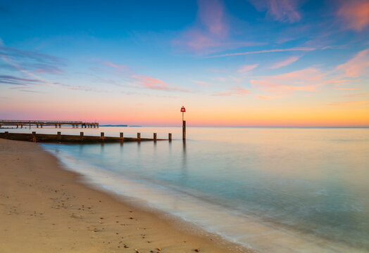 Bournemouth beach illuminated by the setting sun at sunset - Powered by Adobe