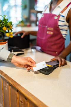 Customer paying with card at garden center counter