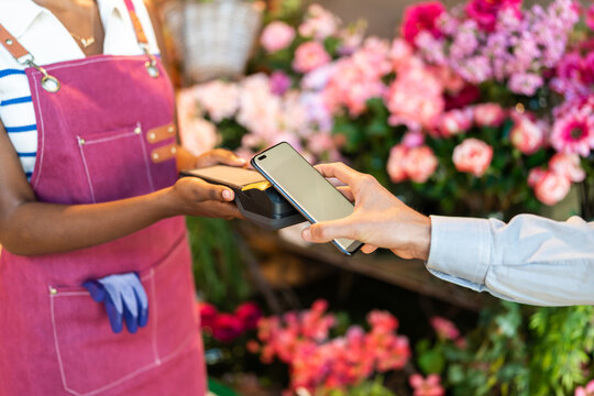 Customer paying with smartphone in a flower shop