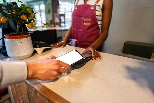 Customer paying with smartphone in garden center using NFC technology