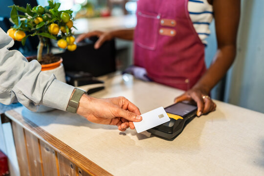 Customer paying with contactless credit card in a garden center