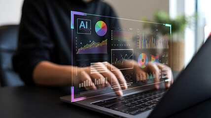 Hands typing on a laptop displaying a futuristic holographic interface with charts and data visualizations