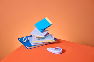 A vibrant display of office supplies, arranged in a playful stack