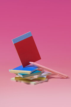A stack of colorful sticky notes, with one red note