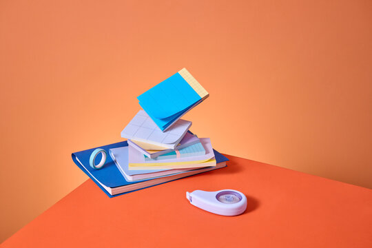 A vibrant display of office supplies, arranged in a playful stack
