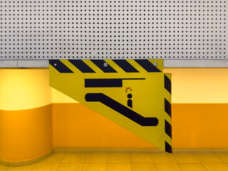 Yellow Warning Sign Indicating Low Clearance in an Indoor Garage Area