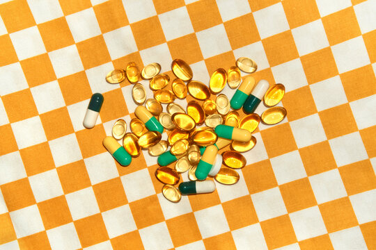 Various Dietary Supplements and pills on a Checkered Tablecloth
