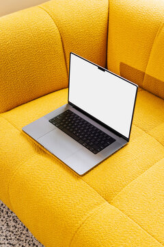 Mockup Laptop with White Screen on Yellow designer Couch