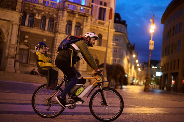 Father and child on bicycle at night