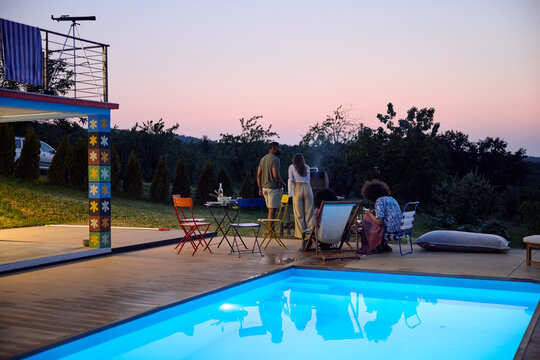 Friends are preparing a barbecue at dusk
