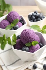 Tasty sorbet with blueberries and mint on table, closeup