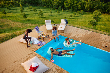 Friends are spending day by the pool