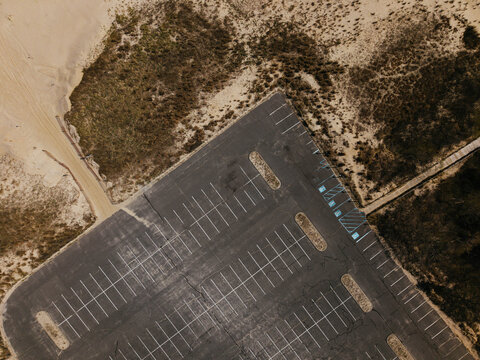 Empty Parking Lot Near Beach Surrounded by Sand Dunes