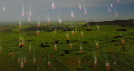 Showing aerial farmland with crop rows unfolding over rolling hills, with binary code overlay