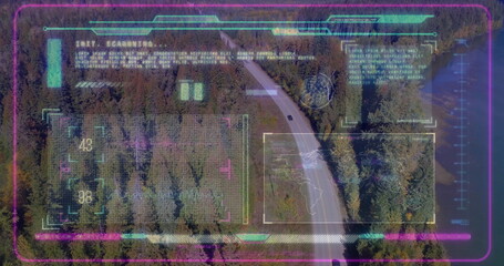 Scanning winding two-lane road through conifer forest from above, with neon holographic overlays