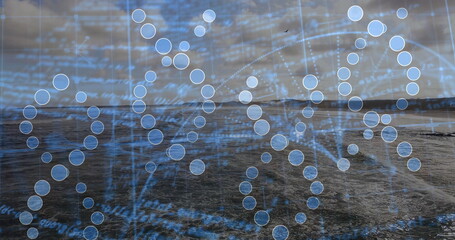 Fototapeta premium Displaying digital DNA helix floating over sea at dusk, with nodes, grid lines and code text