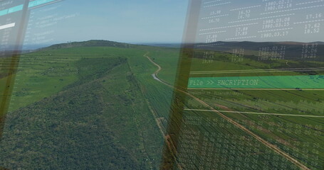 Showing windowpane overlay projecting rolling green hills at office workspace, with encryption GUI