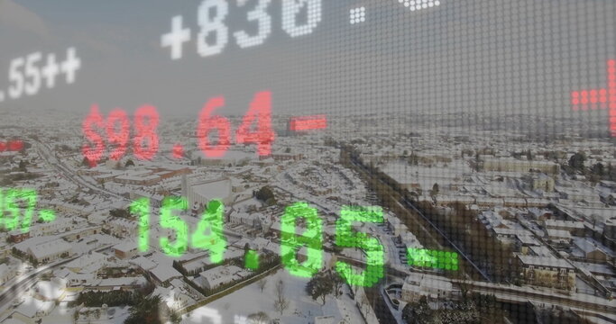 Overlaying green and red stock ticker numbers over snow-covered suburban rooftops and bare trees