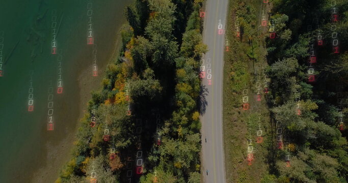 Fototapeta Showcasing winding two-lane road through forest by lake overhead with binary overlay, copy space