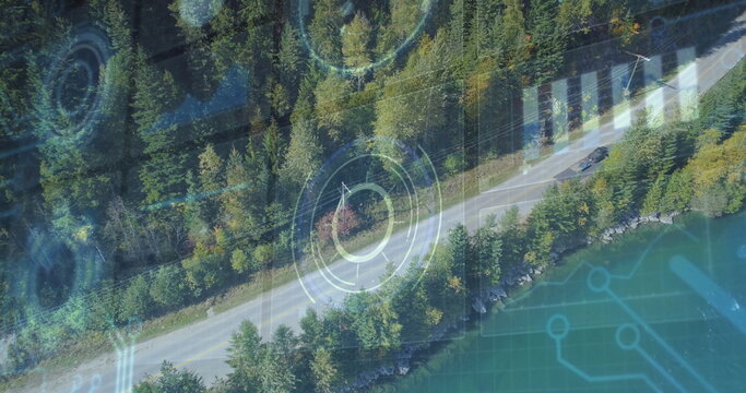 Fototapeta Traveling dark-colored car on two-lane road by turquoise lake among trees, with HUD overlays