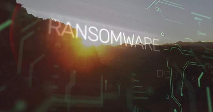 Fototapeta Floating bold RANSOMWARE text hovering over mountain peaks at sunset, with green and white circuits