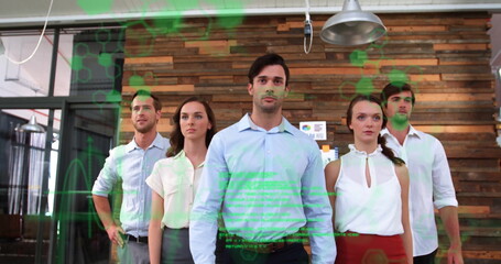 Standing five staff in business attire using digital overlay in modern office with wooden slat wall