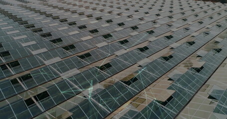 Spanning photovoltaic panels stretching across solar farm grid, with metal rails and supports