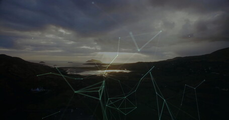 Displaying distant island reflecting on calm inlet water at dusk, with network lines and nodes