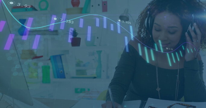 Writing in notebook woman wearing headset analyzing laptop chart overlay in home office, copy space - Powered by Adobe