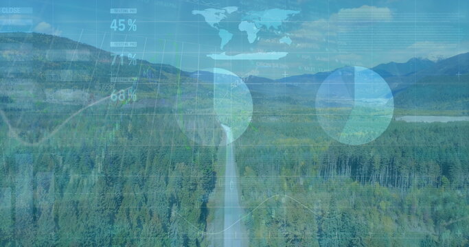 Fototapeta Running asphalt road winding through mountainous forest toward distant peaks, with data overlays