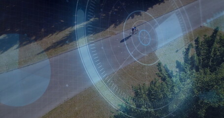 Riding teen cyclist wearing helmet, cycling shorts on bicycle through park, HUD overlay, copy space