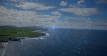 Displaying digital HUD compass gauge hovering above coastal cliffs meeting fields and ocean beyond