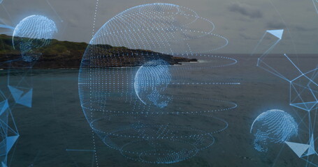 Projecting central holographic globe over coastal shoreline, with mesh network and arrow graphics