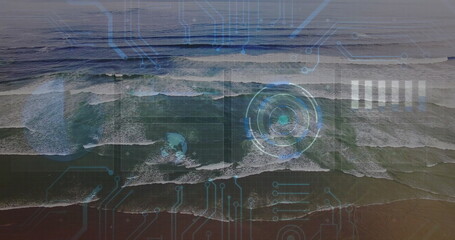 Revealing aerial view showing rolling ocean waves at sandy shoreline, circular HUD circuit overlay
