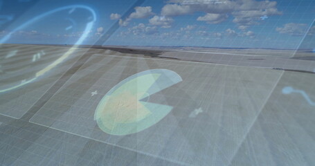 Hovering pac-man data chart overlay moving over farmland, with grid overlay and glowing plus signs